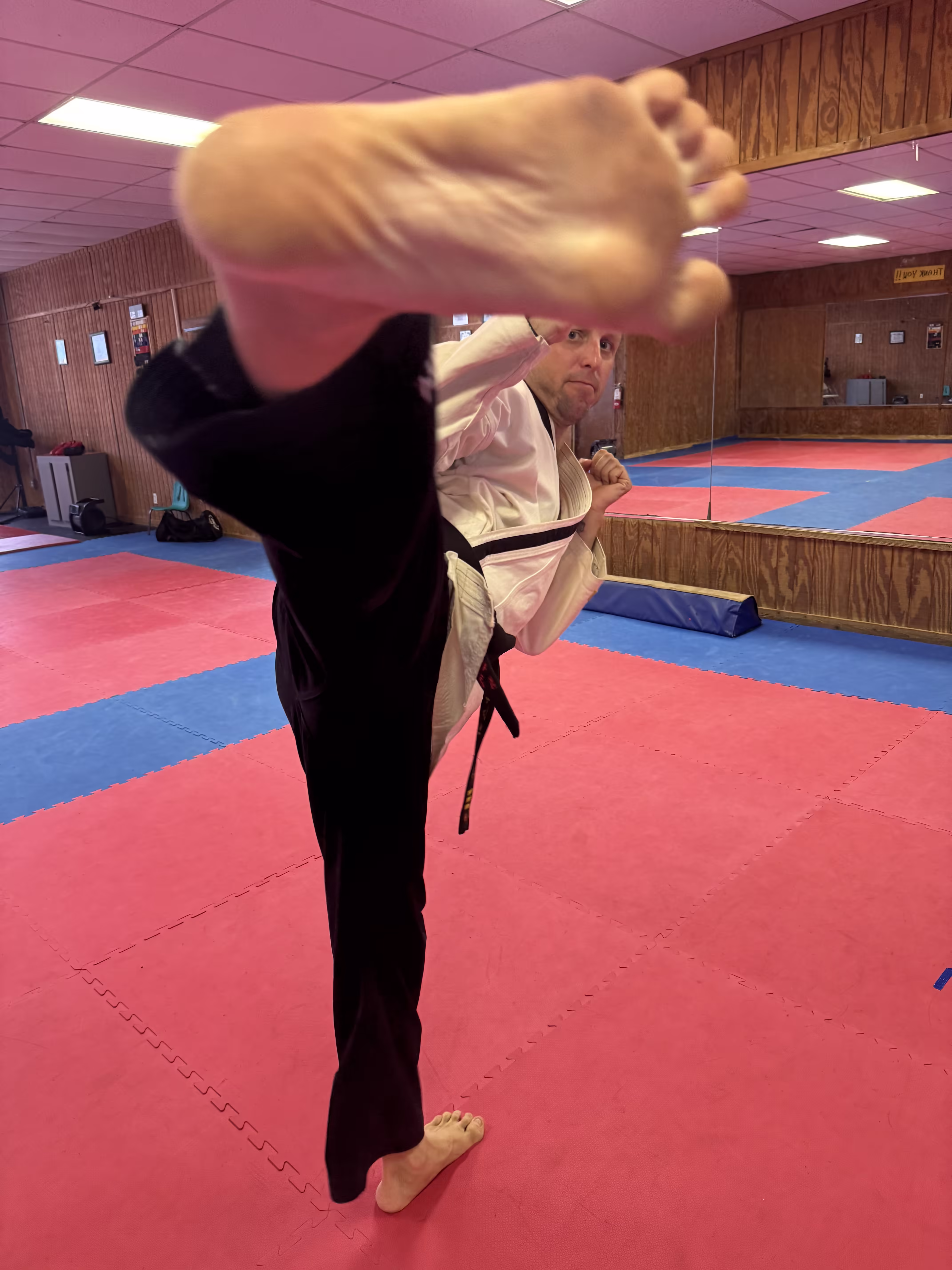 Taekwondo instructor Ryan Koski demonstrating a Taekwondo kick at Dunedin Taekwondo Academy