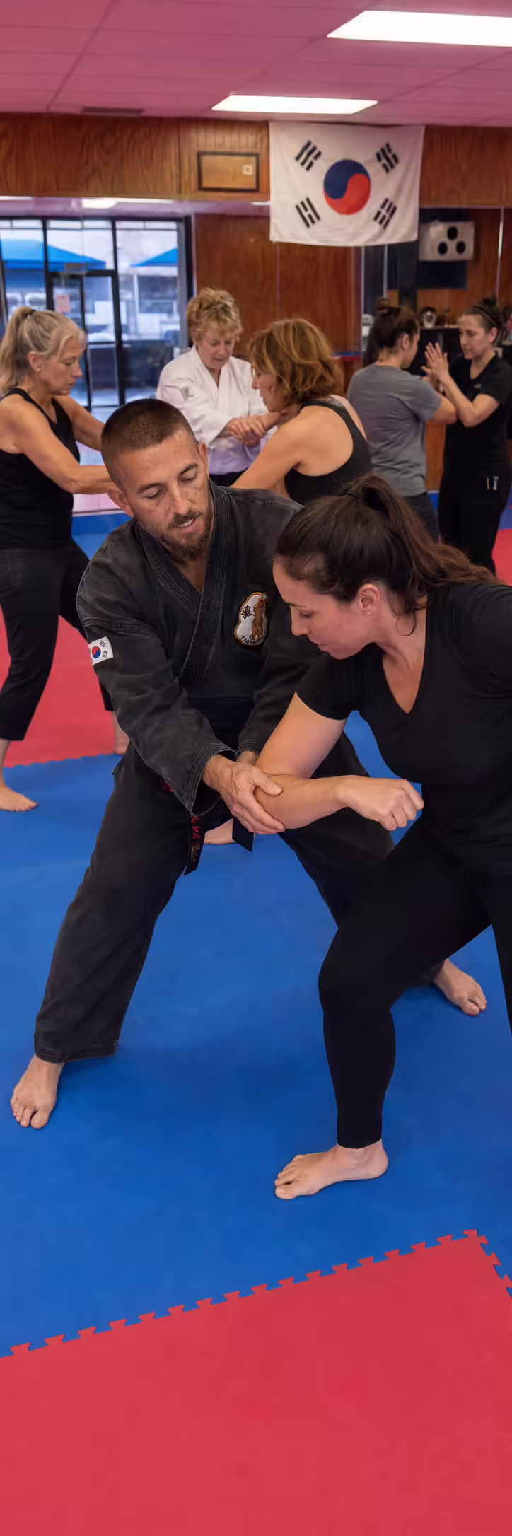 Students practicing controlled sparring and self-defense movement at Dunedin Taekwondo Academy in Dunedin Florida