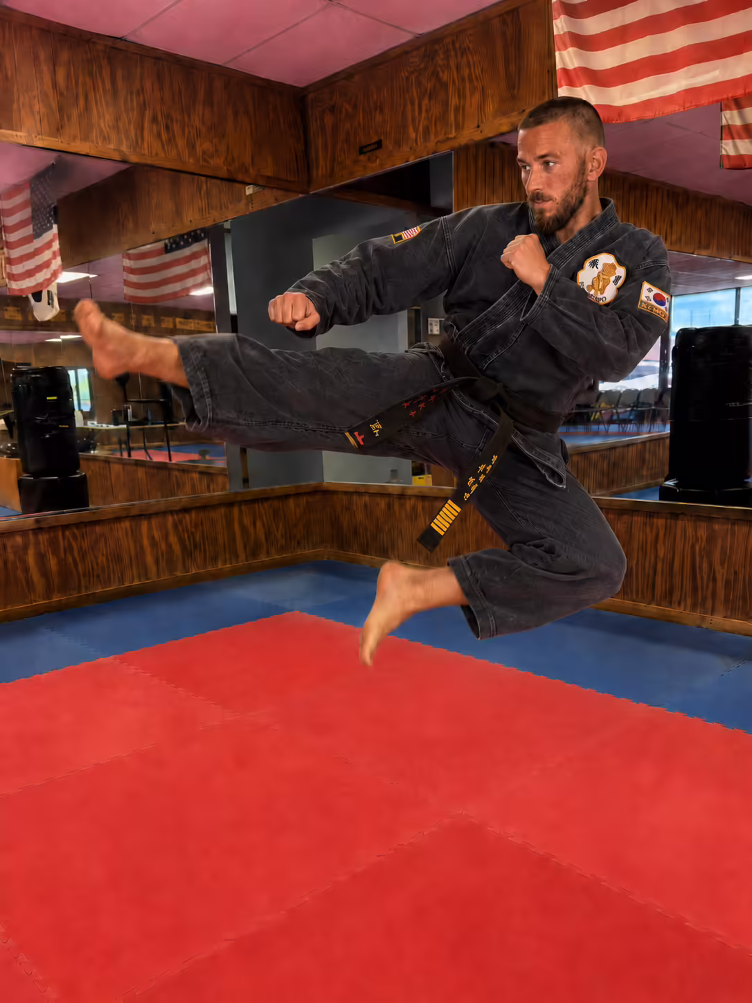 Master BJ Lemminn demonstrating a Taekwondo kick at Dunedin Taekwondo Academy