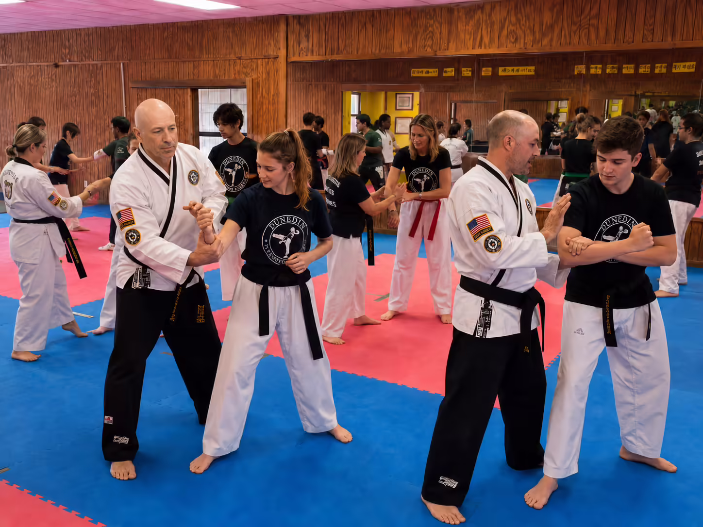 Teen and women students learning self-defense at Dunedin Taekwondo Academy